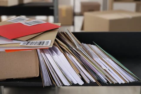 Many different envelopes and parcel on shelf in post office Photos