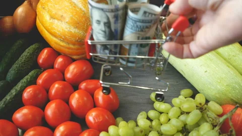 Many different fruit and vegetables and money in basket, green glocery shop,  Stock Footage 161564373