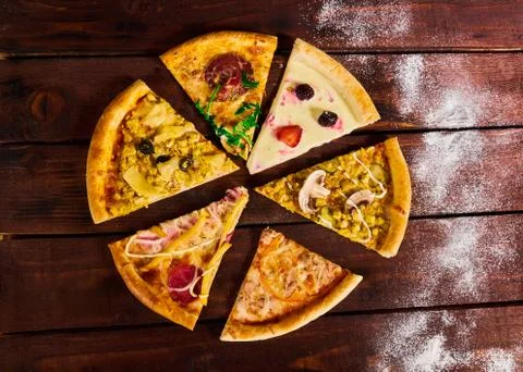 Many different kinds of pizza on the table Stock Photos