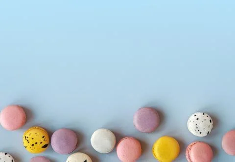 Many different macaroons on blue background. Pink, white and violet French Stock Photos