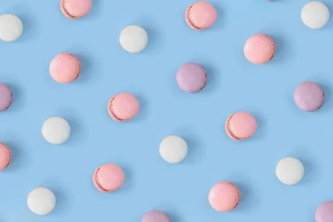 Many different macaroons pattern on blue background. Pink, white and violet Stock Photos