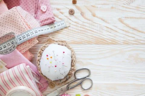 Many different materials for needlework and sewing. A girl / woman is drinking Stock Photos
