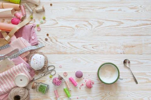 Many different materials for needlework and sewing. A girl / woman is drinking Stock Photos