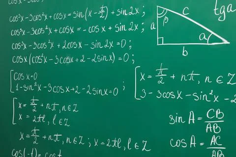 Many different math formulas written on green chalkboard Stock Photos