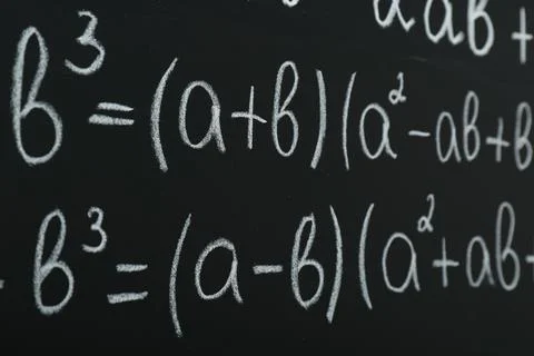 Many different math formulas written on chalkboard, closeup Stock Photos