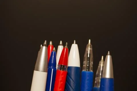 Many different multi-colored pens isolated on black background Stock-Fotos