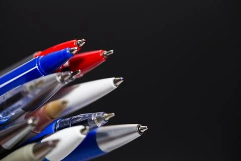 Many different multi-colored pens isolated on black background 스톡 사진