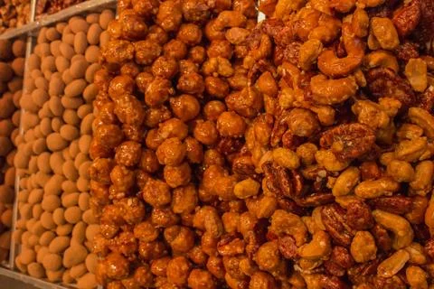 Many different nuts and candies on the counter 스톡 사진