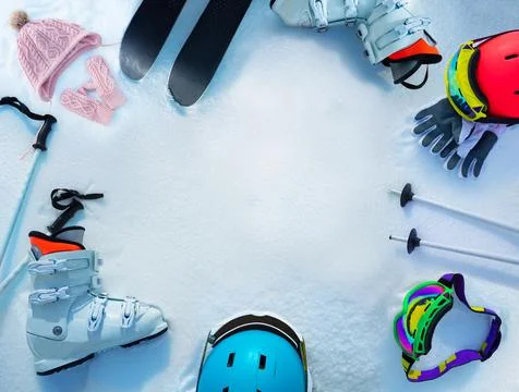 Many different objects ski boots, helmets in snow from above Photos