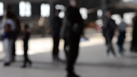 Many different people walking inside large dark building windows light shining Stock Footage 290308719