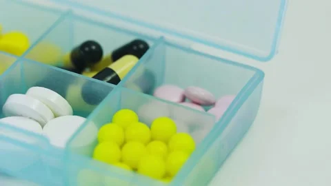 Many different pills in a container for tablets Corona. Covid-19 Video stock 130923410