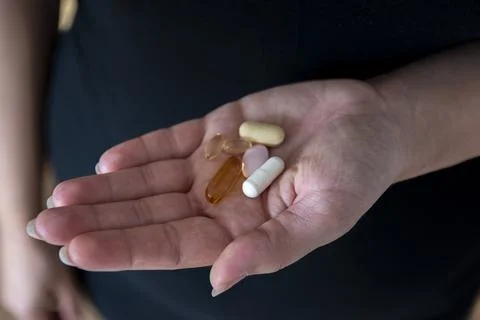 Many different pills on a hand Stock Photos