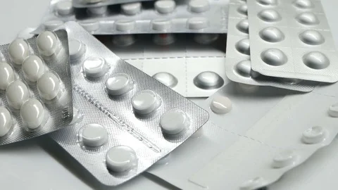 Many different pills tablet blister packages rotating Stock Footage 83692255