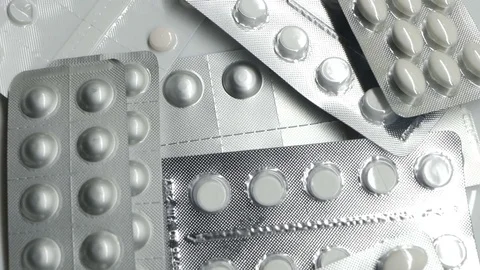 Many different pills tablet blister packages rotating Stock Footage 83692278