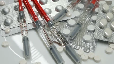 Many different pills tablet blister packages and unused syringes rotate Stock Footage 83692353