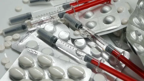 Many different pills tablet blister packages and unused syringes rotate Stock Footage 83692368