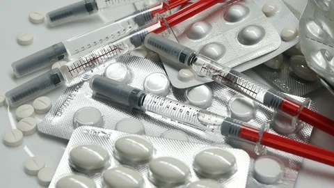 Many different pills tablet blister packages and unused syringes rotate Stock Footage 83692421