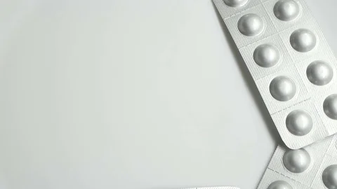Many different pills tablet blister packages rotating on right side Stock Footage 83692457