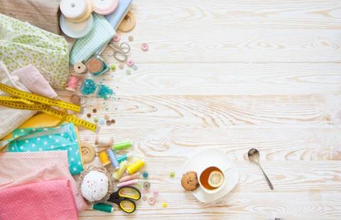 Many different rainbow materials for needlework and sewing. A girl / woman is Stock Photos