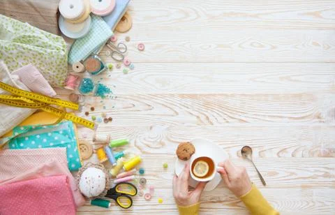 Many different rainbow materials for needlework and sewing. A girl / woman is Stock Photos