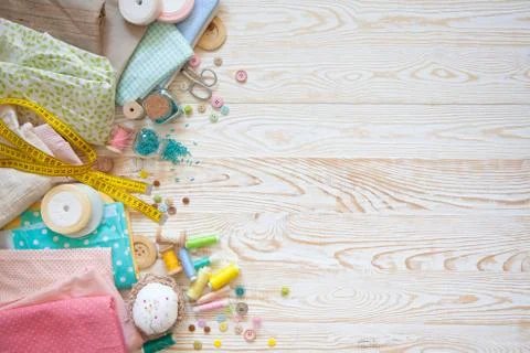 Many different rainbow materials for needlework and sewing. A girl / woman is Stock Photos