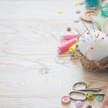 Many different rainbow materials for needlework and sewing. A girl / woman is Stock Photos