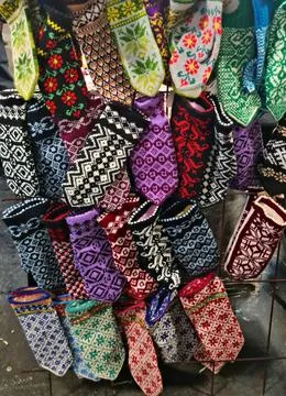 Many different socks and gloves made from natural wool threads are sold at ci Stock Photos