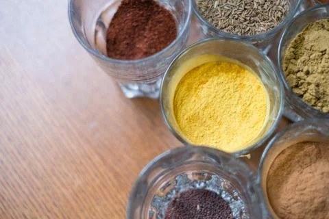 Many different spices in glasses on table Stock Photos