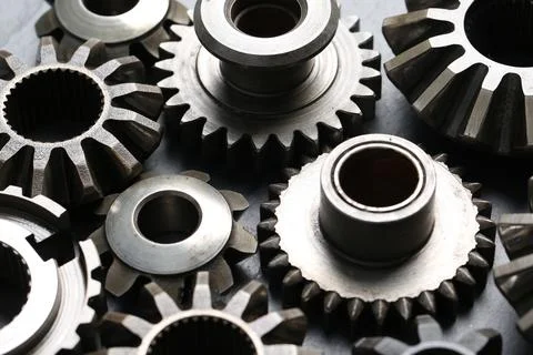 Many different stainless steel gears on grey background, closeup Stock Photos