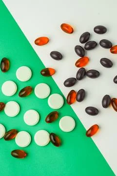 Many different tablet pills on color background, flat lay, with copy space. Photos