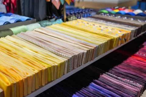 Many different ties of multi colors yellow gradient assortment display at the Stock Photos