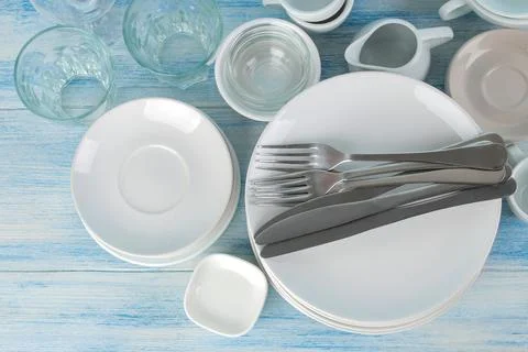 Many different utensils. Tableware on a blue background. Clean tableware. var Stock Photos
