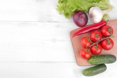 Many different vegetables including, tomatoes, peppers, cucumbers, onions, ga Stock Photos