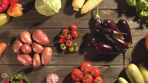 Many different vegetables lie on the table. Видео 79908814