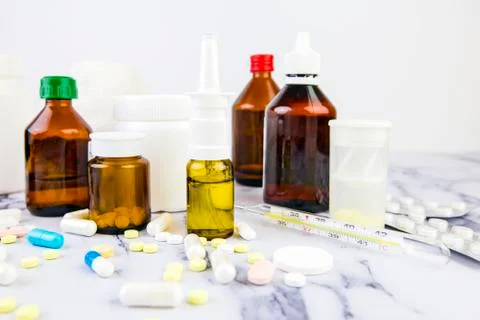 Many different vials and jars with pills and drugs of different colors and si Stock Photos