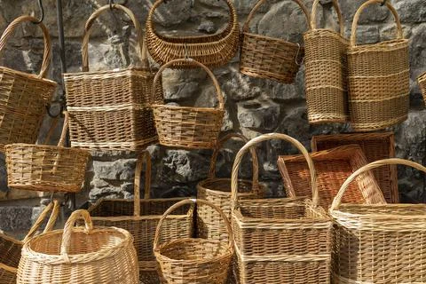 Many different wicker baskets made of natural material as background, closeup Stock Photos