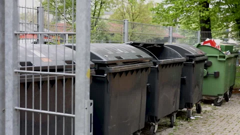 Many dirty garbage can outside in a row Stock-Footage 242990901