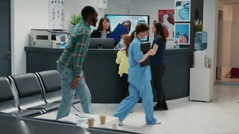 Many diverse people waiting to write medical report at reception desk Video stock 196853782
