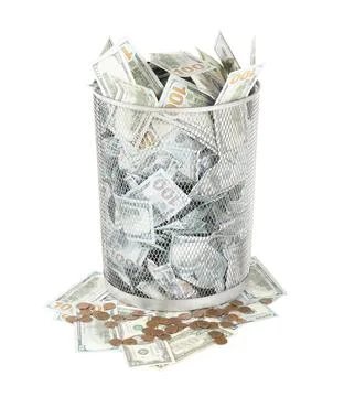 Many dollar banknotes in trash bin and coins isolated on white Fotos Stock