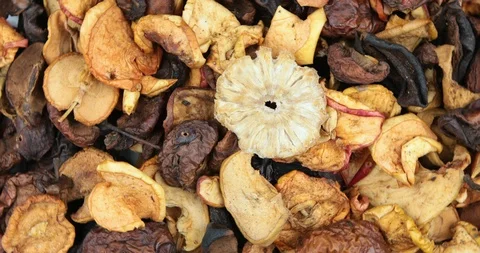 Many dried fruit apples are scattered as a background Stock Footage 107827765