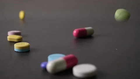 Many drugs falling on the table in slow motion Stock Footage 160557707