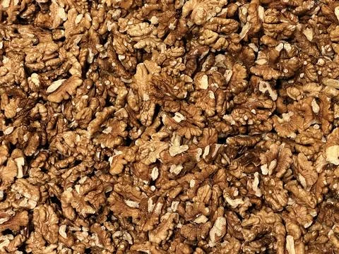 Many dry opened walnut nuts in the market background Stock Photos