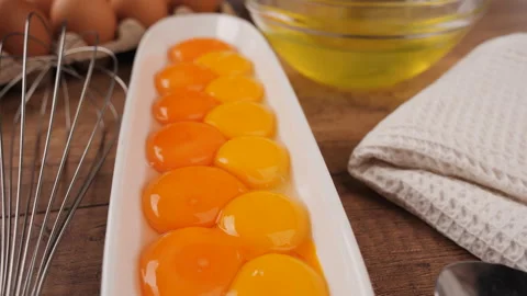 Many eggs yolks separated from white, close up Video stock 200877859