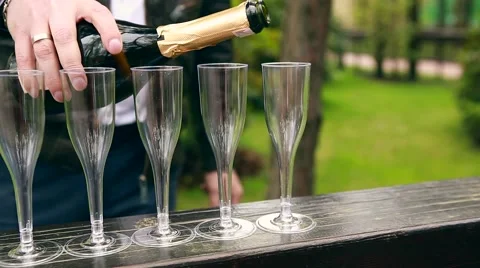 Many elegant empty and half-empty wine glasses of wine or champagne on the Stock Footage 62796381