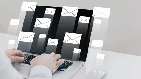 Many emails appear on a laptop screen during a busy work session on a weekday Stock Photos