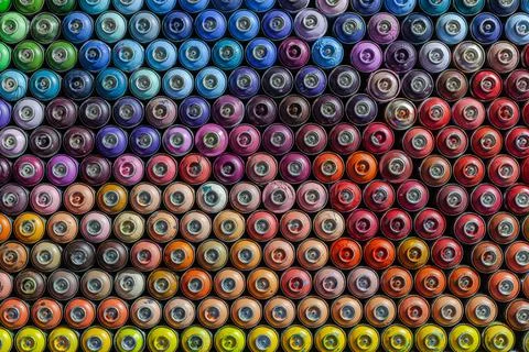Many empty cylinders of paint for graffiti. Tools for street art Stock Photos
