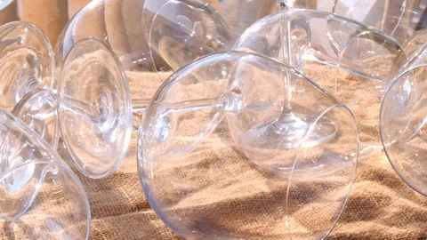 Many empty glass glasses for cognac, whiskey originally lie on burlap, with Stock Footage 124427073