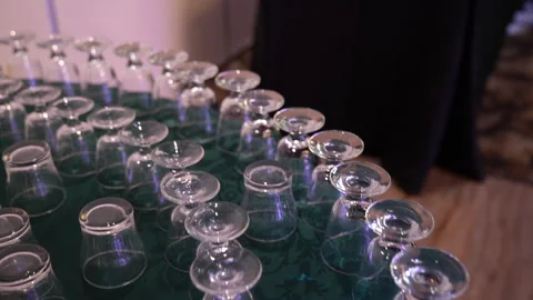 Many empty glasses arranged neatly on a dark green tablecloth 스톡 동영상 335270823