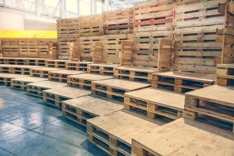 Many empty pallets stored in warehouse Stock Photos