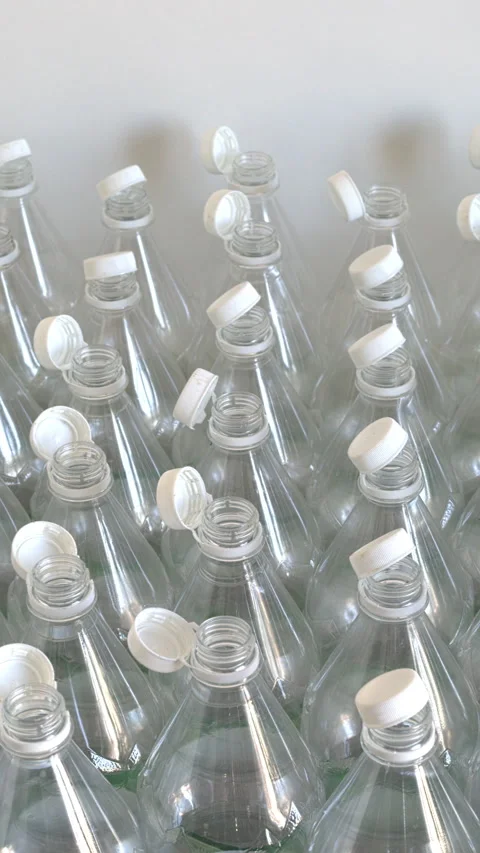 Many empty PET bottles with stationary plastic caps.  Vertical video. Stock Footage 327454909